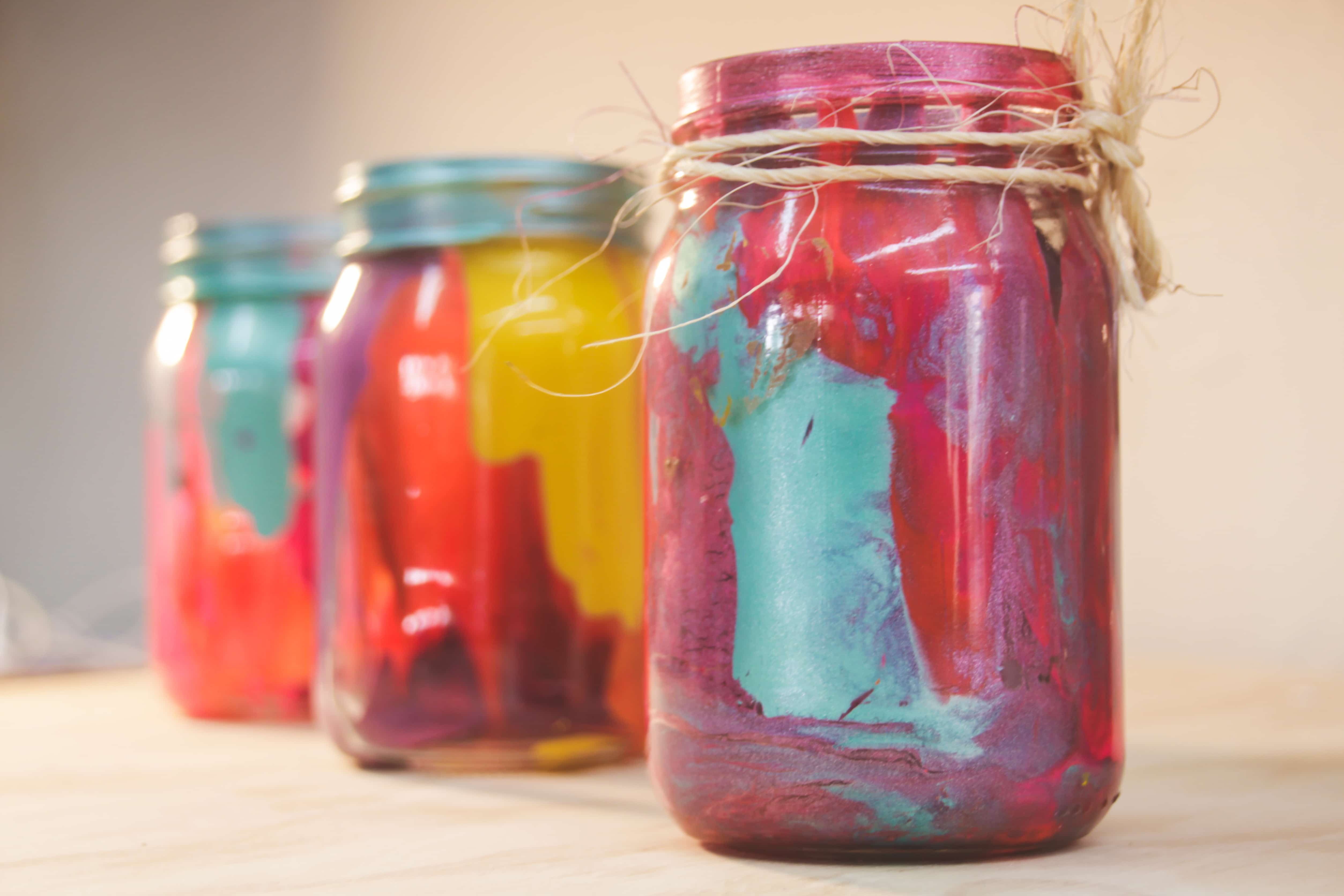 Painted mason jars with twine wrapped around the top