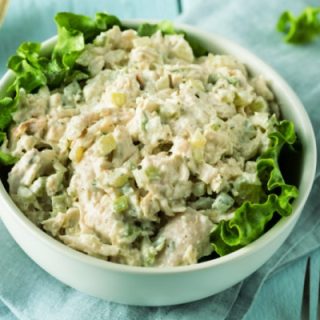 bowl of chicken salad on a bed of lettuce
