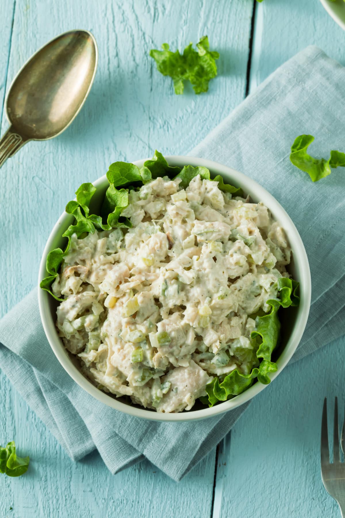 bowl of chicken salad on a blue table