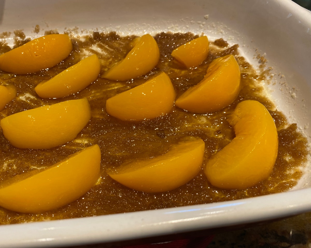 peaches lined up on bottom of cake pan