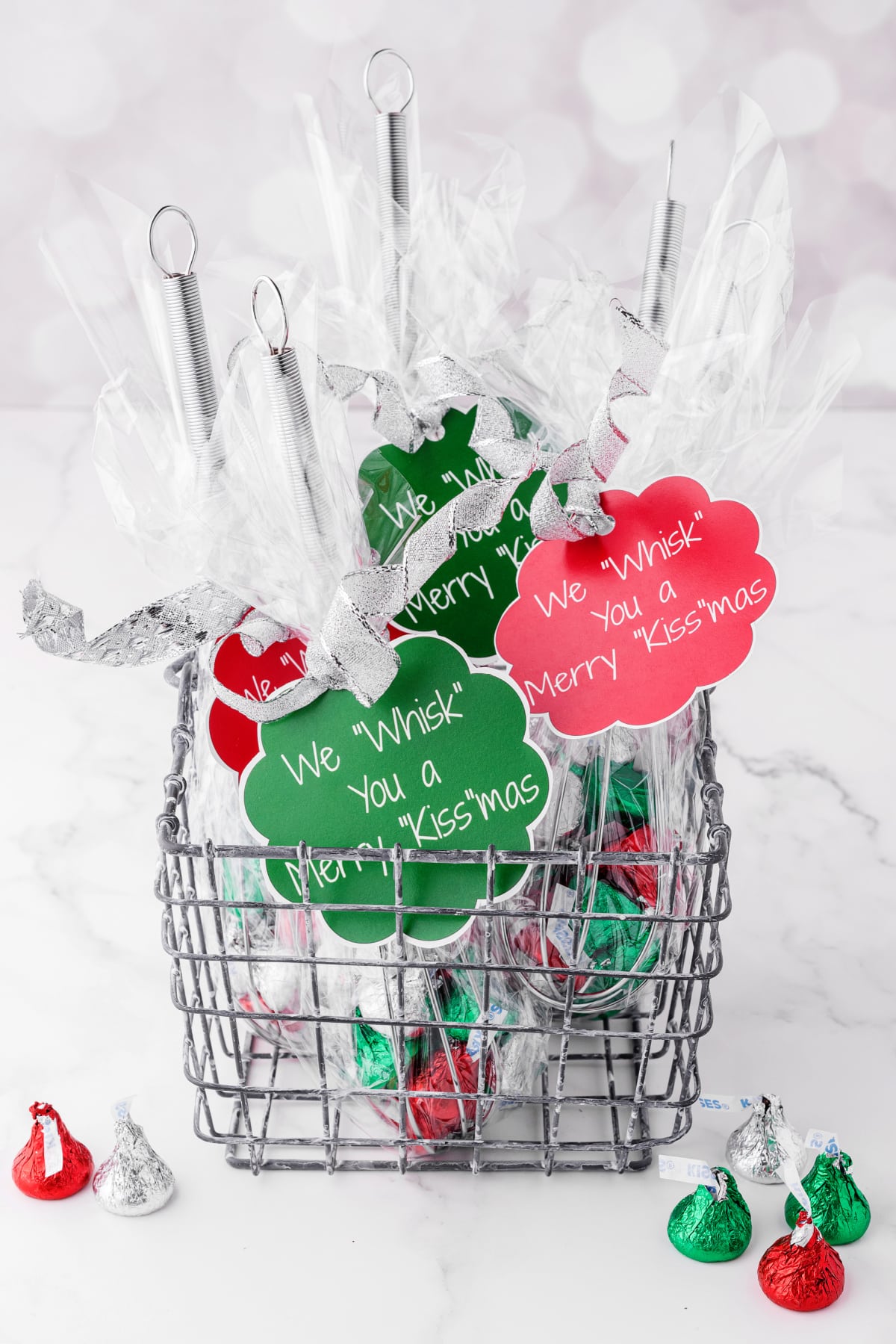 Christmas gifts in a wire basket with red and green tags