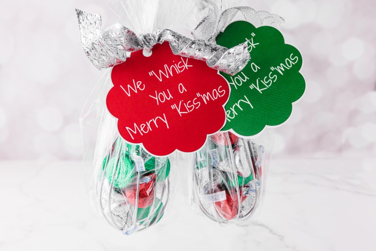 two whisks full of candy with gift tags