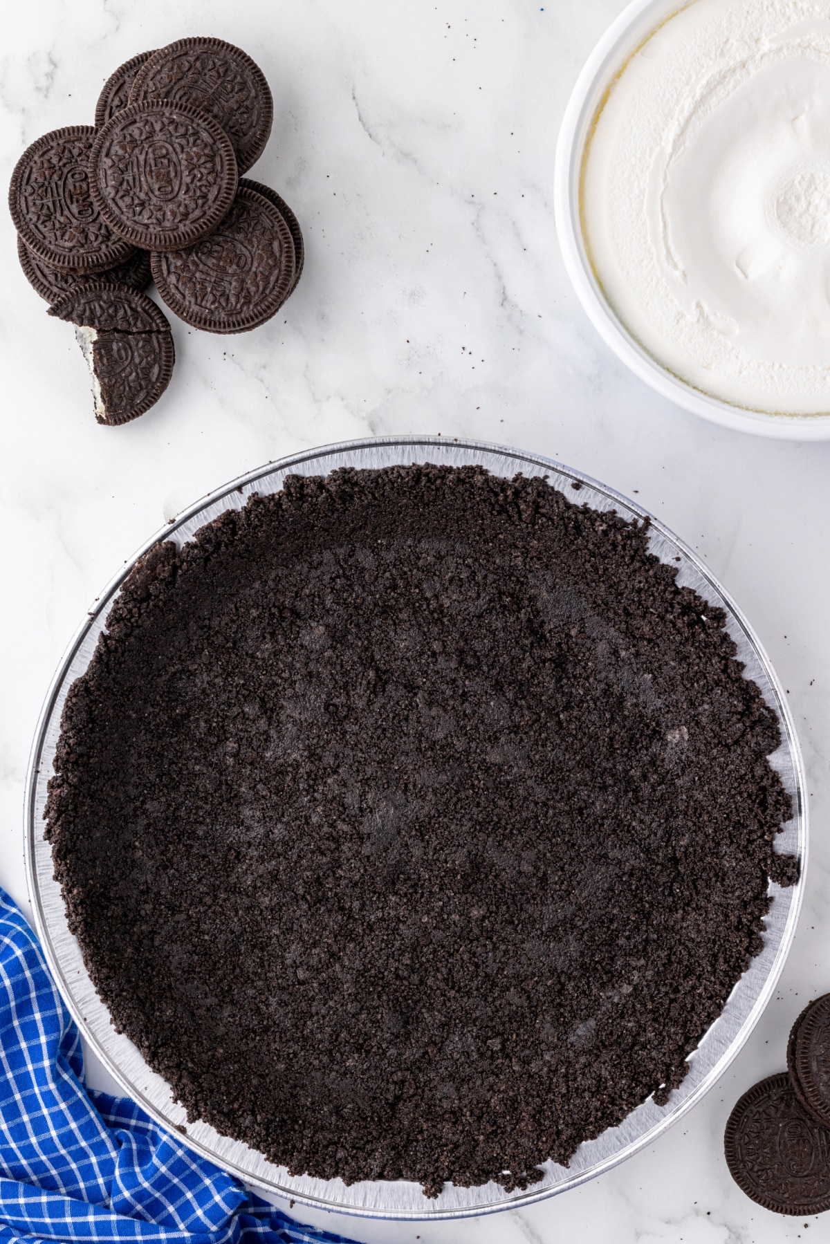 crushed Oreo cookies in the bottom of a pie plate as a pie crust