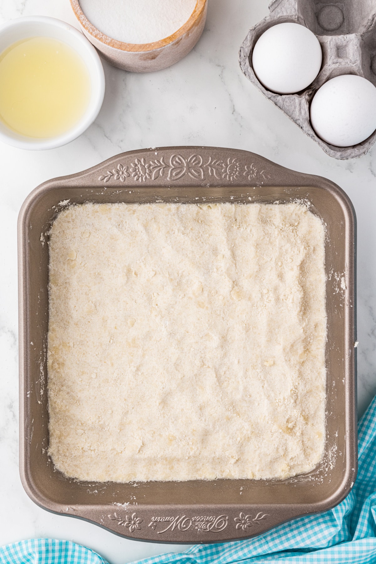 dry ingredients pressed into the bottom of a square baking pan to make lemon bar crust