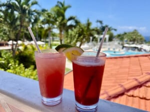 Two colorful red and pink drinks on the balcony at Sandals Ochi