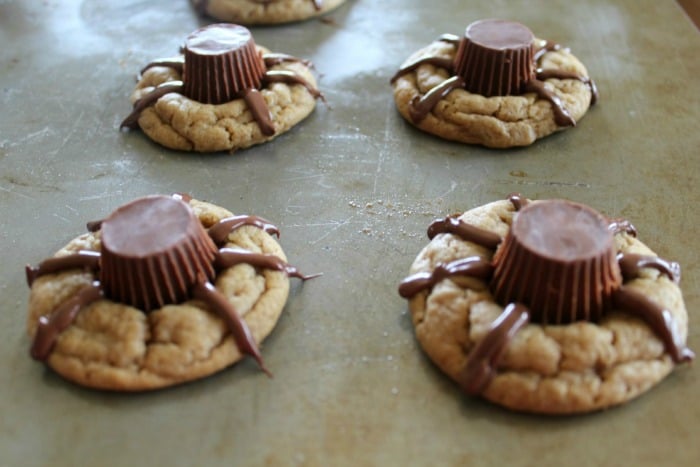 Make cute Halloween cookies by using mini Reese's Peanut Butter Cups and drawing chocolate legs