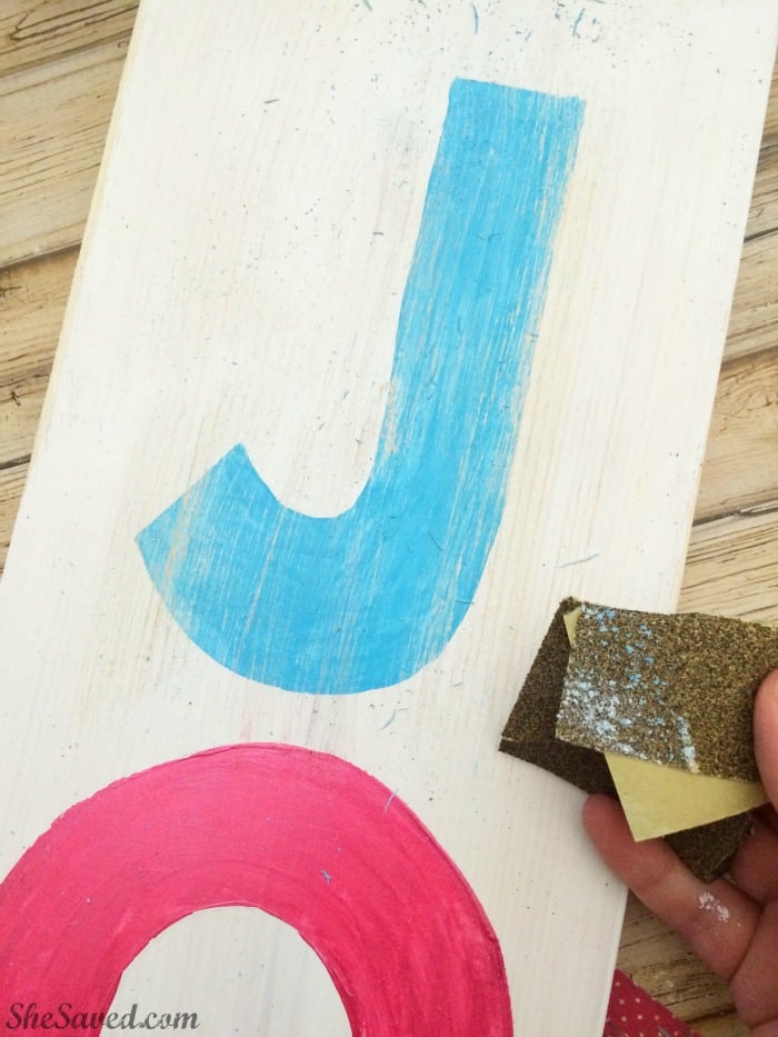This fun homemade Joy sign will add so much to your holiday decor, and it's easy to make!