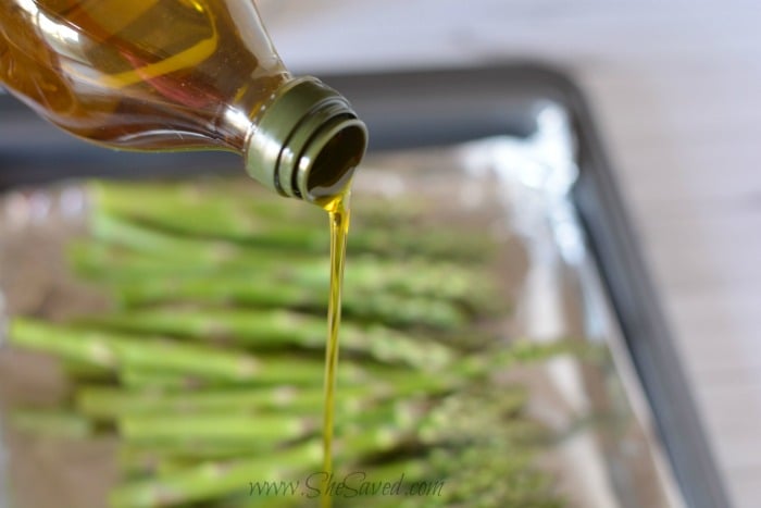 Pouring Olive Oil Over Asparagus