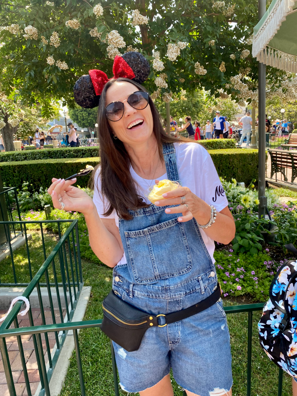 Keri Lyn from She Saved eating Dole Whip at Disneyland in Mickey Mouse Ears