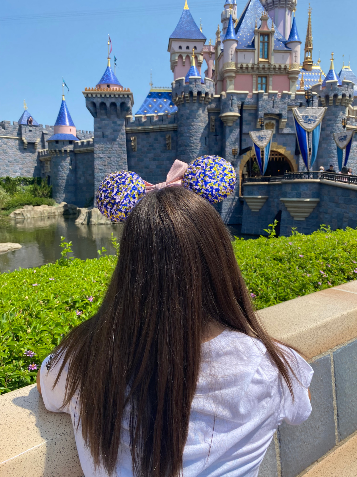 Girl in Mickey Mouse Ears staring at the Disneyland Castle