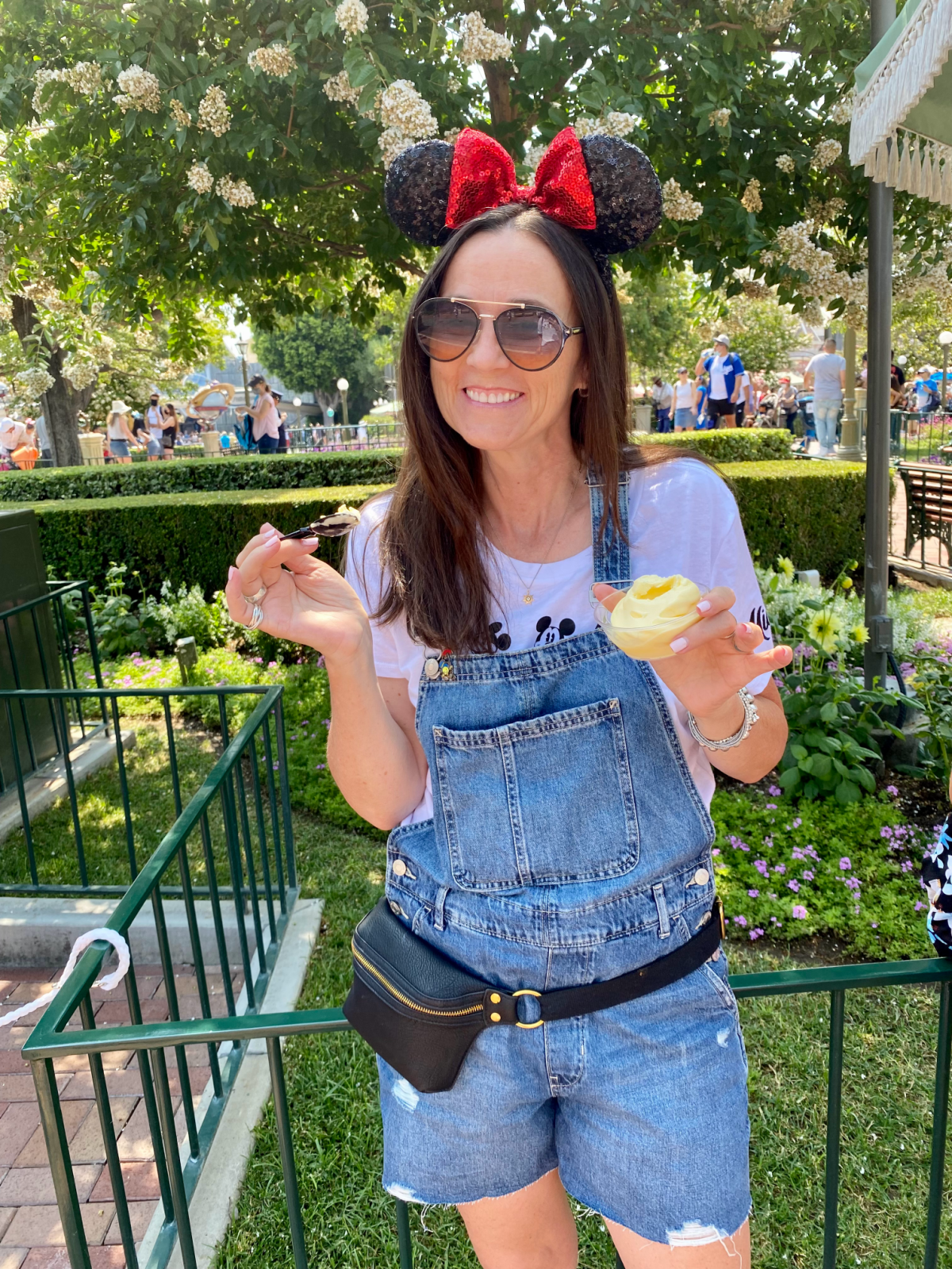 Enjoying Dole Whip at Disneyland with Mickey Ears on 