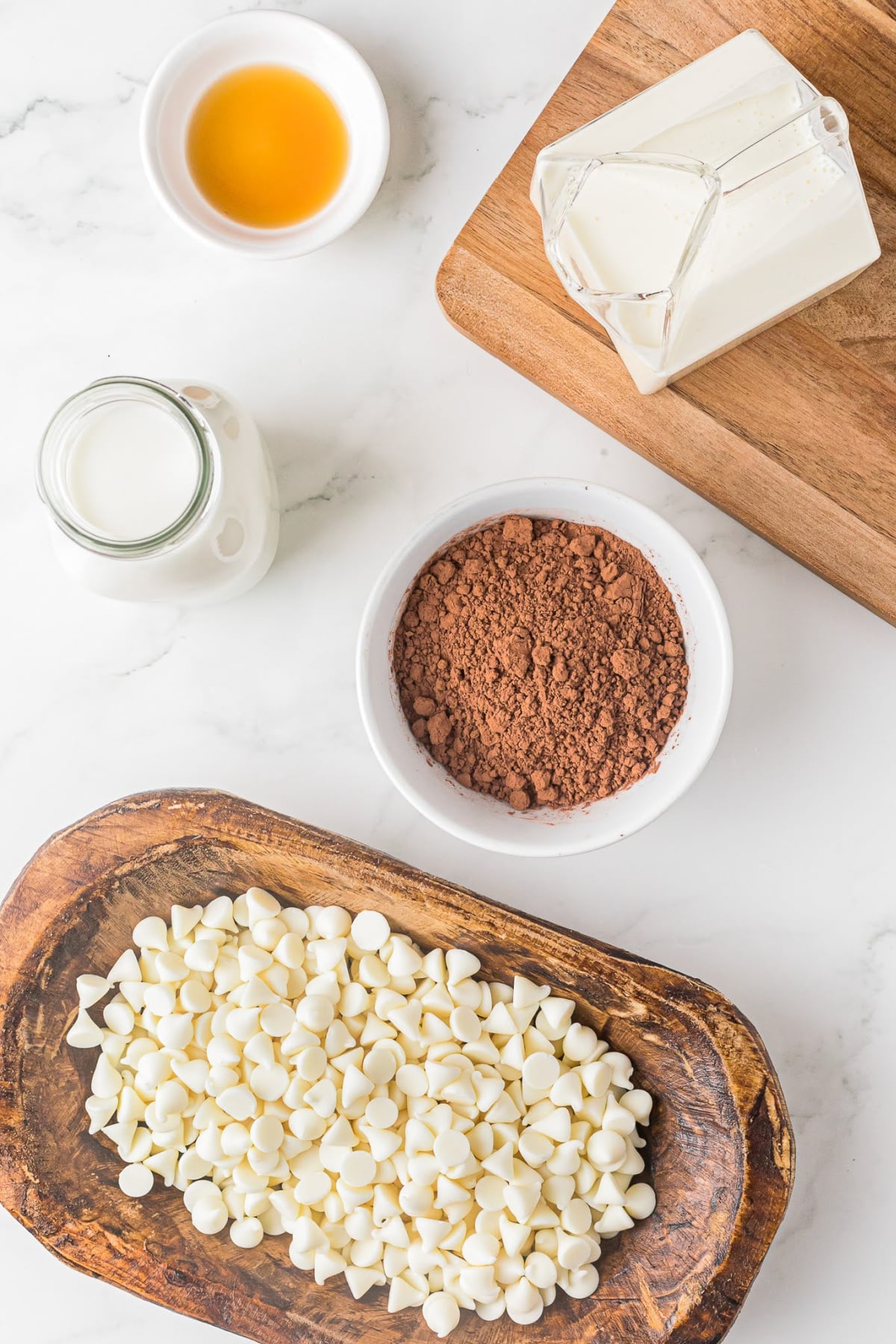bowl of white chocolate chips, cocoa powder, milk and other ingredients for making hot chocolate