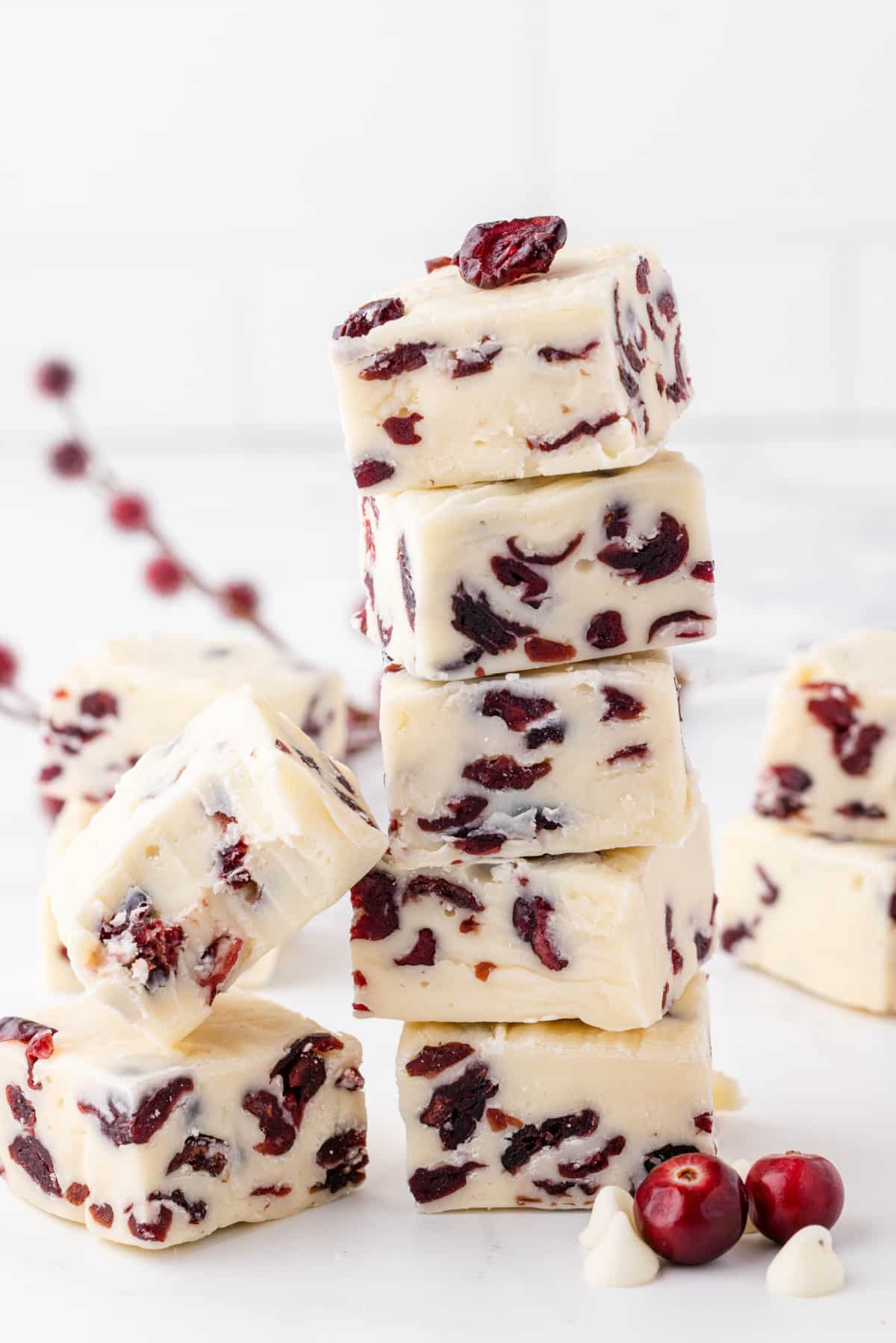stacked white fudge on a counter with holiday decor