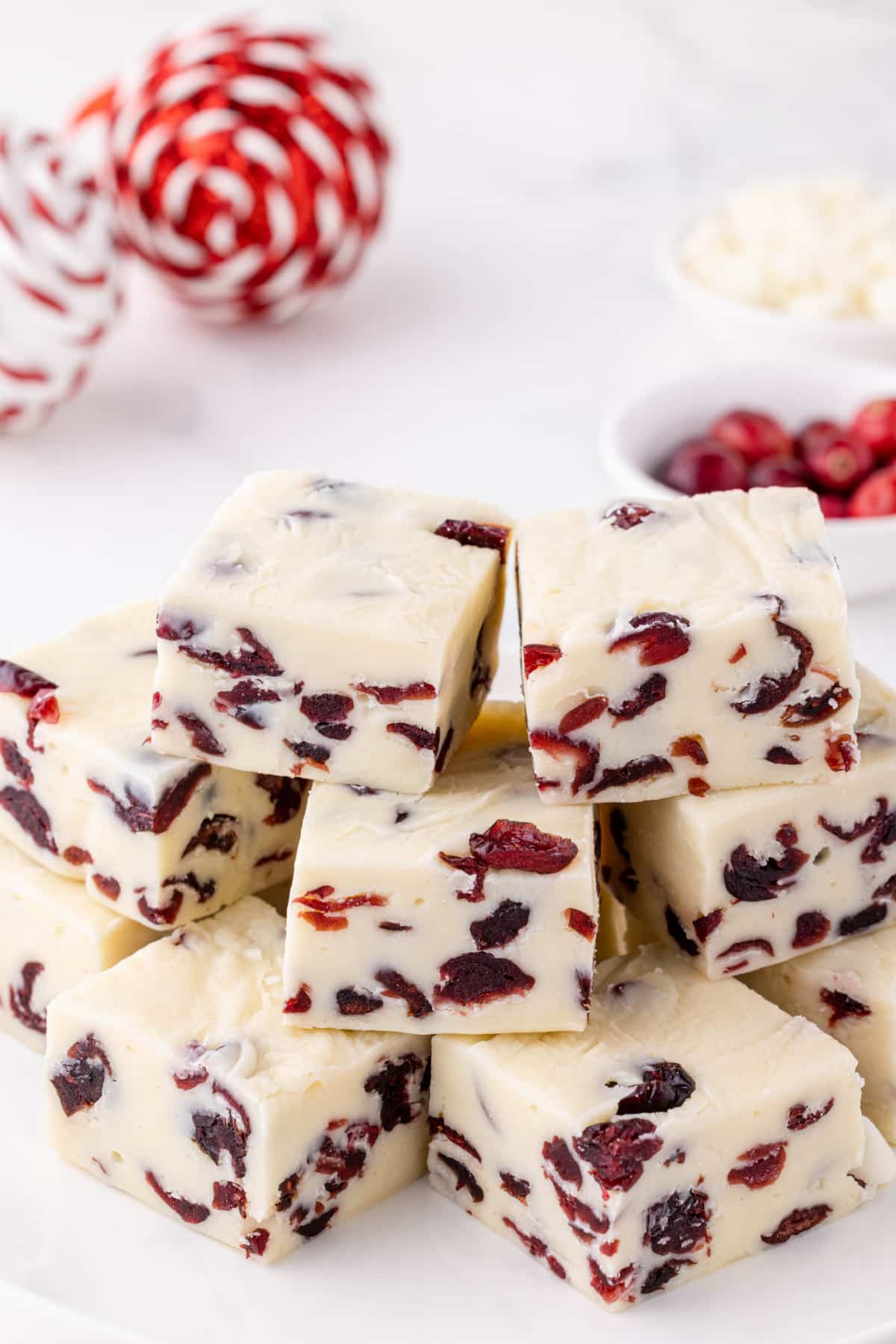 white chocolate fudge stacked on counter with Christmas ornaments