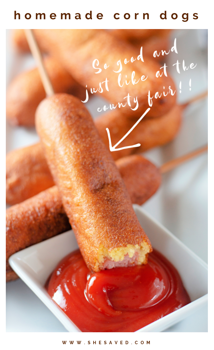image of corndog dipping in ketchup with bite taken out of it 