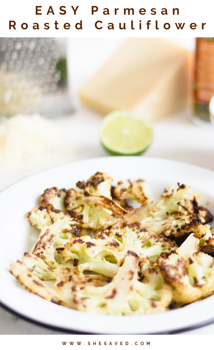 Roasted Cauliflower on a white plate with cheese, lime and oil in the background