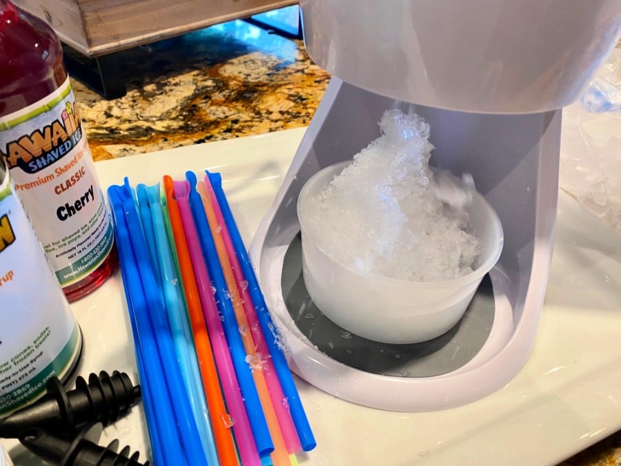 shaved ice coming out of snow cone machine