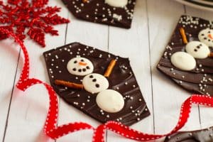 chocolate pieces with snowmen on a white wood